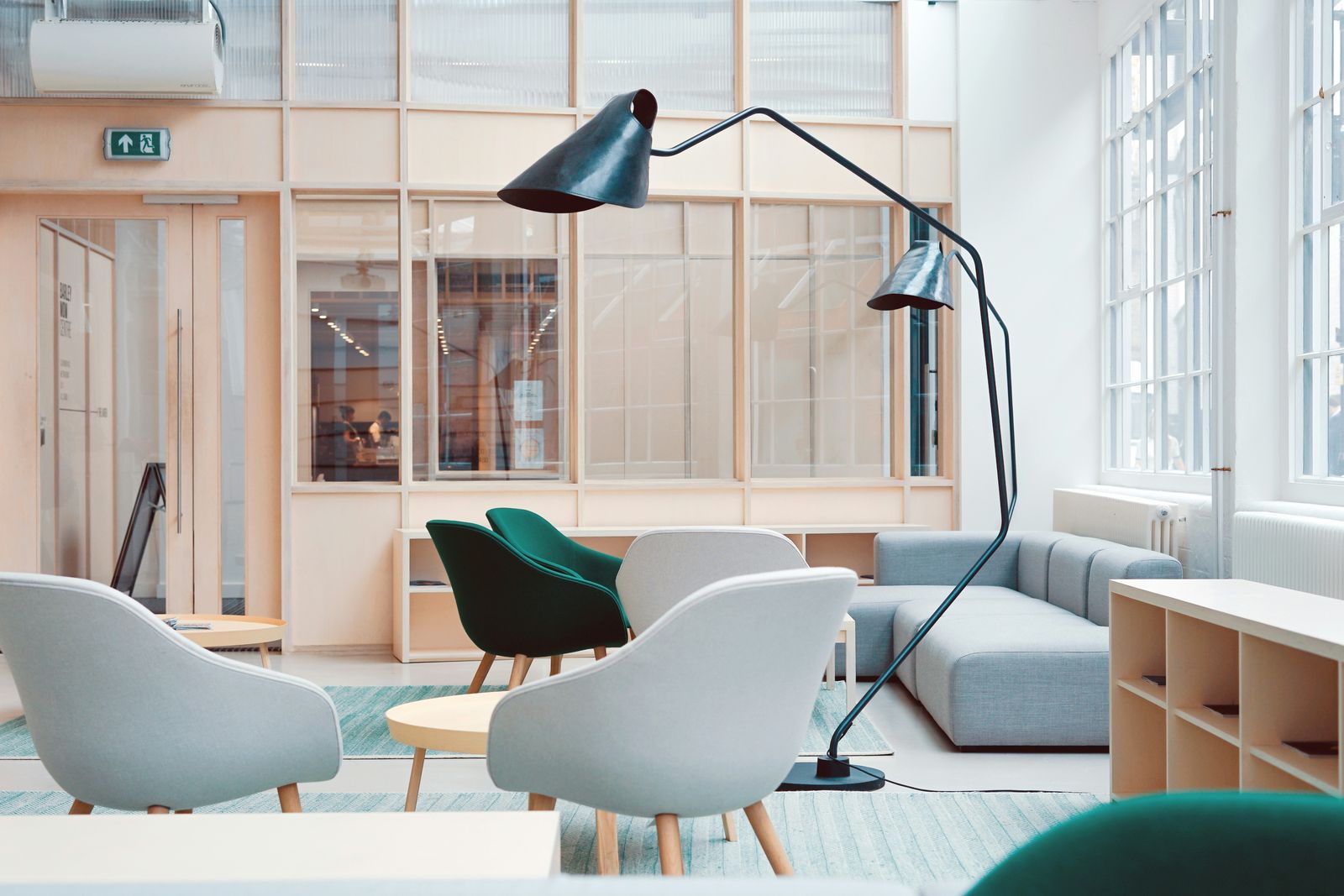 Contemporary lounge with pale upholstered chairs, a sofa and a black arc floor lamp